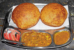 LIP-SMACKING Makhan Lal Tika Ram serves puri and aloo-chole,  a dish peculiar to the state of UP.