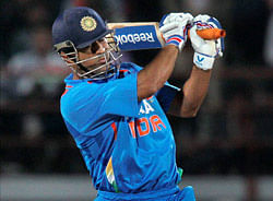 India's M S Dhoni plays a shot during the first ODI cricket match against England in Rajkot on Friday. PTI Photo