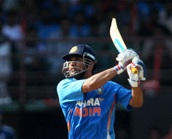 Indias M S Dhoni plays a shot during the 2nd ODI match against England in Kochi on Tuesday. PTI Photo