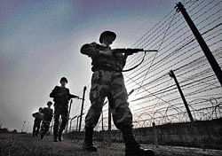 Border Security Force soldiers patrol along the border fence at an outpost in Abdulian, 38 km southwest of Jammu.  A ceasefire took hold January 17 in disputed Kashmir after the Indian and Pakistani armies agreed to halt deadly  cross-border firing that threatened to unravel a fragile peace process. AFP