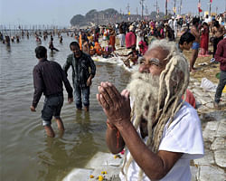 A sadhu offers prayer after taking holy dip in Ganga during Maha Kumbh Mela at Sangam in Allahabad on Saturday. PTI