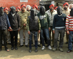 Indian police personnel present six arrested men, accused of a gang rape in Punjab state, for an appearance at court in Gurdaspur on Januray 13, 2013. Six men have been arrested over the rape of a passenger on a coach in India, police said, weeks after the gang-rape and murder of a student on a bus in New Delhi sparked nationwide protests. AFP PHOTO
