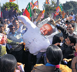 BJP workers burn an effigy of Sushilkumar Shinde during a protest over his controversial remarks on the party and RSS in Jaipur on Monday. PTI