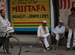 Indian shopkeepers sit outside closed shops during shutdown protests after the arrest of Muslim law maker Asaduddin Owaisi in Hyderabad, India, Monday, Jan. 21, 2013. According to local news reports, the arrest in connection with a 2005 case sparked violent protests by supporters and shutdown in parts of the city Monday. AP Photo