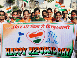 School students, with Tricolour painted on their faces, display banner on the eve of Republic Day in Jalandhar on Friday. PTI