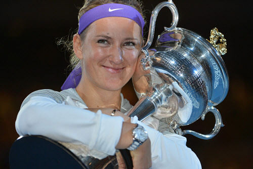 Belarus's Victoria Azarenka poses with the winner's trophy after her victory over China's Li Na during the women's singles final on day 13 of the Australian Open tennis tournament in Melbourne on January 26, 2013.