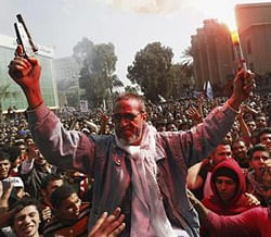 The father of an Al Ahly fan who was killed in Port Said celebrates with soccer fans, also known as ''Ultras'', in front of the Al Ahly club after hearing the final verdict of the 2012 Port Said massacre in Cairo January 26, 2013.  Credit: Reuters/