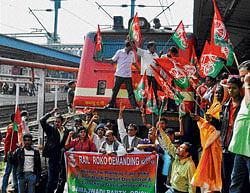 Samajwadi Party workers stop a train during a demonstration against hike in price of diesel, in Bhubaneswar. PTI
