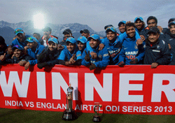Indian cricket team pose with the trophy of the One Day International cricket match series won against England by 3-2, after their 5th ODI match at HPCA Stadium in Dharamshala on Sunday. PTI