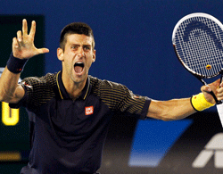 Novak Djokovic of Serbia celebrates defeating Andy Murray of Britain in their men's singles final match at the Australian Open tennis tournament in Melbourne, January 27, 2013. Djokovic became the first man to win three successive Australian Open titles in the professional era. REUTERS