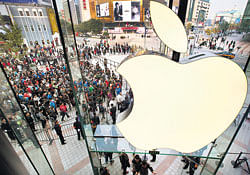 People line up to enter a newly-opened Apple Store in Wangfujing shopping district in Beijing. AP File Photo