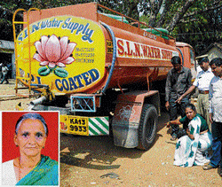 Relatives of Sunandamma (inset) show the spot where she was run over by a water tanker at Bapuji Nagar. DH Photo