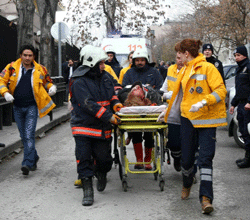 Rescuers take on February 1, 2013 a victim of a blast outside the US Embassy in Ankara to a waiting ambulance. Two security guards were killed in the blast outside the US embassy, local television reported, amid speculation it was a suicide attack. The force of the explosion damaged nearby buildings in the Cankaya neighborhood where many other state institutions and embassies are also located. AFP