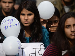 Indian protestors holds balloons with slogans during a protest against last month's gang rape and murder of a student, in New Delhi on January 27, 2013. India's president on the eve of India's Republic Day celebrations said it was time for the country to 'reset its moral compass' in the wake of the savage gang rape and murder of a student last month that ignited nationwide protests. AFP PHOTO