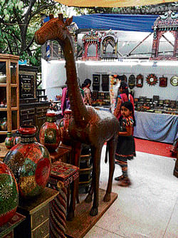 want to own one: A giraffe made of teak and brass on  display at the Chitrakala Parishat. DH Photo