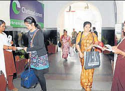 Discipline: Ticket collectors distribute awareness pamphlets on cleanliness and decency, to passengers at Mysore railway station on Wednesday.  dh photo