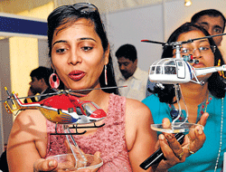 Visitors take a look at the miniatures at a stall.