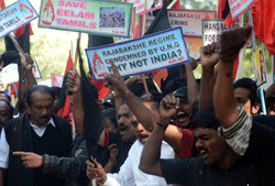 Indian activists from Marumalarchi Dravida Munnetra Kazhagam (MDMK) shout slogans against Sri Lankan President Mahinda Rajapakse against his visit to India during a protest in New Delhi on February 8, 2013. Tamil groups are demanding that the Sri Lankan president return to his country. Sri Lankan forces crushed Tamil rebels in May 2009 after nearly three decades of brutal fighting with the conflict claiming up to 100,000 lives, according to UN estimates. AFP PHOTO