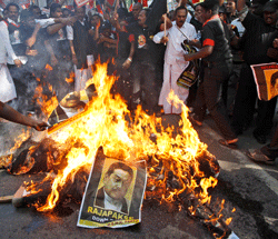Indian Tamil activists of the Marumalarchi Dravida Munnetra Kazhagam (MDMK) party burn an effigy and portraits of Sri Lankan President Mahinda Rajapaksa during a protest in New Delhi, India, Friday, Feb. 8, 2013. Various pro-Tamil groups and leaders are protesting Rajapaksas visit holding him responsible for the killing of innocent Tamils during the civil war in Sri Lanka. Rajapaksa is on a personal visit to the country. (AP Photo