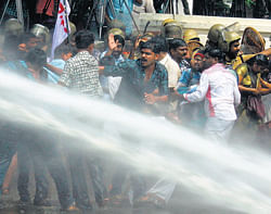Riot police fire water cannons at protesters in Kerala demanding the resignation of Rajya Sabha Deputy Chairman P J Kurien over allegations that he raped a schoolgirl 17 years ago.  The lawmaker was acquitted in 2005 but he has come under new pressure after the storm over the deadly gang-rape in Delhi in December.