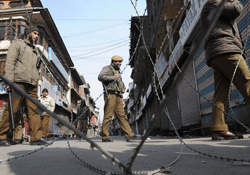 Indian police patrol a deserted street on the third day of a curfew in Srinagar on February 11, 2013. Security forces have imposed a curfew in much of Indian Kashmir following the execution February 9 of Mohammed Afzal Guru, convicted of helping to plot the deadly 2001 attack on the Indian parliament, while a general strike was in force on Monday to mark the 29th anniversary of the execution of Maqbool Bhat, a leader of the Jammu Kashmir Liberation Front (JKLF). AFP PHOTO