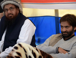 Leader of Defence of Pakistan Council Hafiz Saeed (L) sits with chairman of Jammu Kashmir Liberation Front, Yasin Malik on his hunger strike against the execution of Kashmiri separatist, Mohammed Afzal Guru, in Islamabad on February 10, 2013. Mohammed Afzal Guru, a one-time fruit merchant, was hanged at New Delhi's Tihar Jail early Saturday over his role in a deadly attack on the Indian parliament in 2001, after President Pranab Mukherjee rejected a mercy appeal. AFP