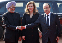 France's President Francois Hollande (R) shakes hands with India's Prime Minister Manmohan Singh as his partner Valerie Trierweiler (C) looks on during Hollande's ceremonial reception at the forecourt of India's presidential palace Rashtrapati Bhavan in New Delhi February 14, 2013. Hollande is on a two-day long state visit to India. REUTERS