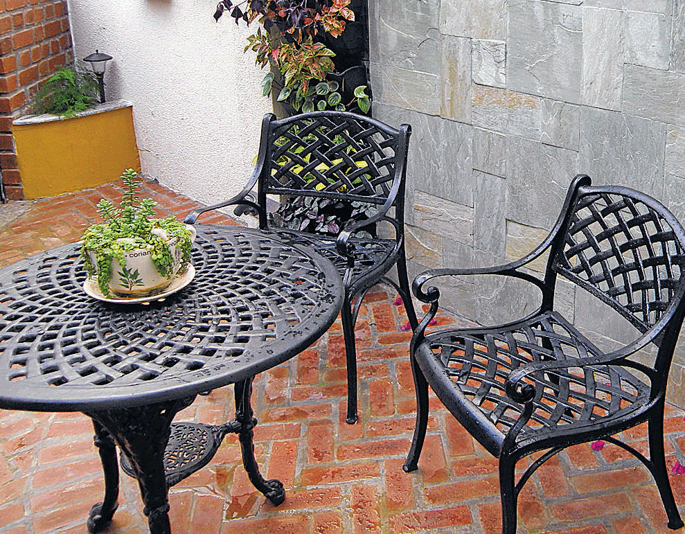 VERTICAL GROWTH Wrought iron panels embedded with plant holders. (Photos by the author)