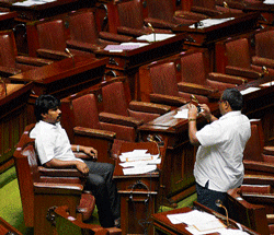 say cheese: A legislator takes a snap of Minister Raju Gowda on his mobilephone on the last day of the Legislative Assembly session at the Vidhana Soudha on Friday. dh Photo