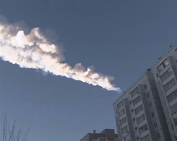 The trail of a falling object is seen above a residential apartment block in the Urals city of Chelyabinsk, in this still image taken from video shot on February 15, 2013. A powerful blast rocked the Russian region of the Urals early on Friday with bright objects, identified as possible meteorites, falling from the sky, emergency officials said. REUTERS/OOO Spetszakaz