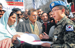 Raja Farooq Haider, center, leader of the opposition and former prime minister of Pakistani Kashmir hands over a protest memorandum to an official of the United Nations to condemn the hanging of Afzal Guru, in Muzaffarabad, capital of Pakistani Kashmir.