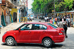 Is it safe : Vehicles occupy the left side of the road abutting Lansdowne Building in Mysore on Monday. dh photo