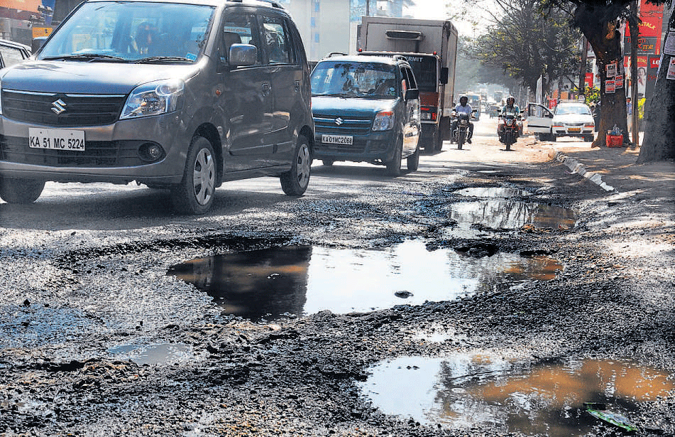 Inconvenient Huge: potholes in front of Forum Auto House on Hosur Road.