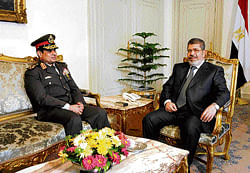 Litmus test: Egyptian President Mohammed Morsi with  his Minister of Defense, Lt  Gen  Abdel-Fattah el-Sissi, at the presidential headquarters in Cairo on Thursday. AP