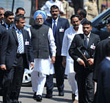 Indian Prime Minister Manmohan Singh (4L) visits the site of the bomb blast at Dilsukh Nagar in Hyderabad on February 24, 2013. Indian Prime Minister Manmohan Singh flew Sunday to Hyderabad to visit some of the 117 injured in twin bombings last week which also killed 16 people. AFP PHOTO