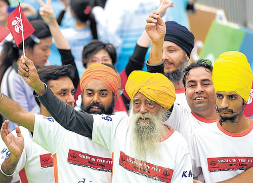 age no bar Fauja Singh waves the Hong Kong flag after the 10km race at the Hong Kong Marathon on Sunday. AP