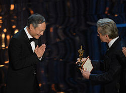 Director Ang Lee accepts the Oscar for Best direting from actor Michael Douglas onstage at the 85th Annual Academy Awards on February 24, 2013 in Hollywood, California. AFP PHOTO