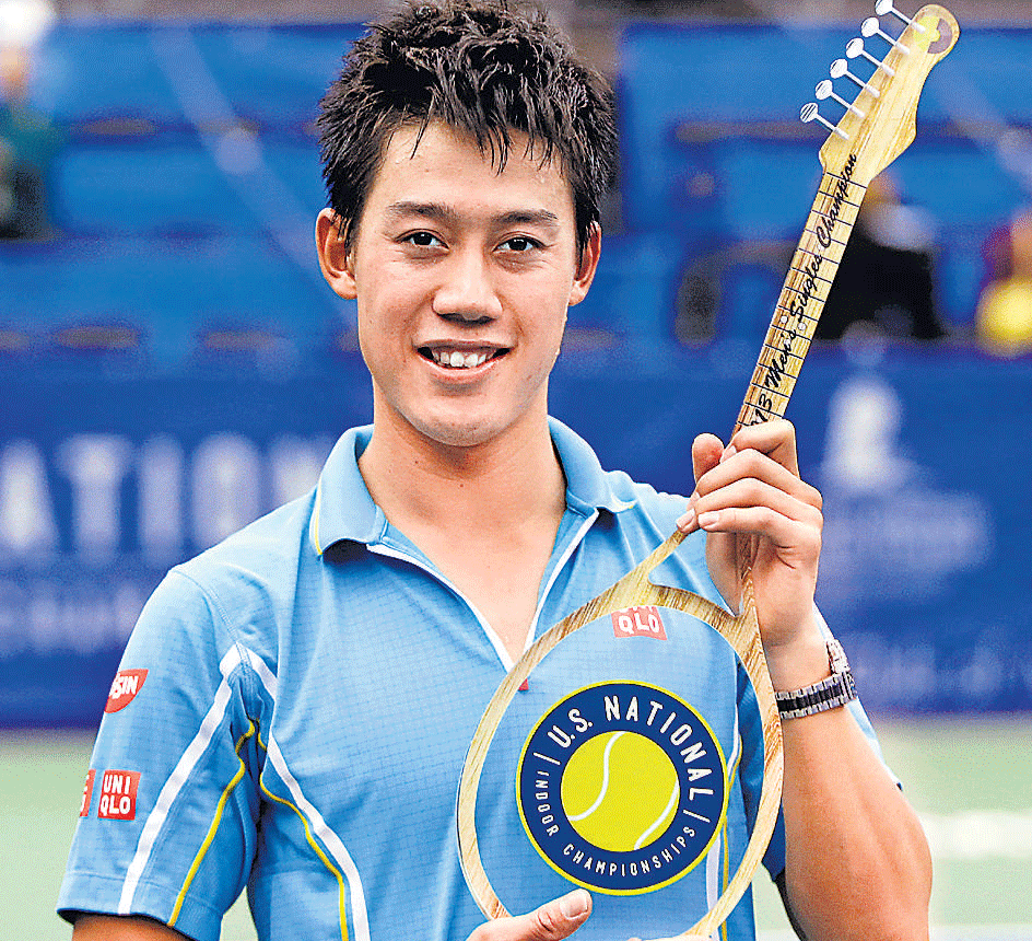 Strings of Success: Japans Kei Nishikori poses with the Memphis Open trophy after defeating Spaniard Feliciano Lopez in the final  on Sunday. AFP