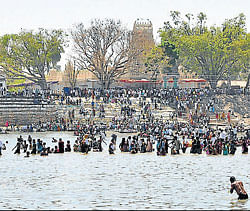confluence: Thousands of devotees take a holy dip at Tirumakoodalu, T Narsipur taluk, on the last day of Kumbh Mela on Monday.