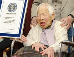Misao Okawa (R) receives a certification from an official of Guinness World Records in Osaka, western Japan, in this photo taken by Kyodo February 27, 2013. Reuters Image