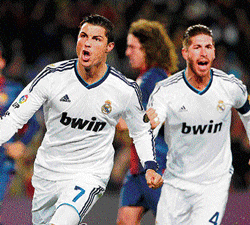the run continues: Real Madrids Cristiano Ronaldo (left) celebrates with Sergio Ramos after scoring the opening goal against Barcelona on Tuesday. AP