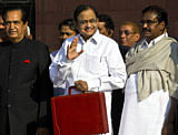 Indian Finance Minister P. Chidambaram (C) waves as he leaves the Finance Ministry to present the Union Budget at Parliament in New Delhi on February 28, 2013. India's finance minister presents his annual budget that is expected to see him opt for austerity over free-spending populism despite elections due early next year and a sharply slowing economy. AFP PHOTO