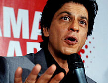 Actor Shah Rukh Khan gestures during a press conference on the occasion of the Toyota University Cricket Championship (TUCC) first match of the season in Mumbai on February 23, 2013. AFP PHOTO