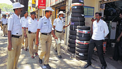 Pedestrians space: Traffic policemen on Friday warn traders on JC Road against encroachment of footpaths. DH Photo