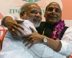 India's main opposition Bharatiya Janata Party (BJP) senior leader and Chief Minister of Gujarat, Narendra Modi (L), hugs BJP President Rajnath Singh during a BJP National Council two day meeting in New Delhi on March 2, 2013. Amid calls for a larger role for him Modi won singular praise from BJP President Singh for being the 'most popular' chief minister having registered 'never before' three consecutive electoral wins for the party in Gujarat. In a poll published in January, 36 percent of voters surveyed said Modi would make the best prime minister -- well ahead of his likely election rival Rahul Gandhi of the ruling Congress party who had just 22 percent. AFP PHOTO