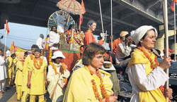Foreign devotees taking part in a procession at Maha Kumbh.