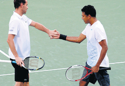Mahesh Bhupathi (right) and Michael Llodra  celebrate a point in the Dubai Championship final. AP