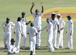 Pakistan cricketer Muhammad Irfan (C) celebrates with teammates the dismissal of South African batsman Robin Peterson during the first day of the third Test match between South Africa and Pakistan on February 22, 2013 at Super Sport Park in Centurion. AFP PHOTO