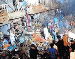 Rescue workers at the blast site in Karachi on Sunday. AFP