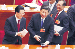 Communist Party chief Xi Jinping (centre), Chinese President Hu Jintao (left) and Chinese Premier Wen Jiabao leave  after the opening session of the National Peoples Congress in Beijings Great Hall of the People on Tuesday. AP